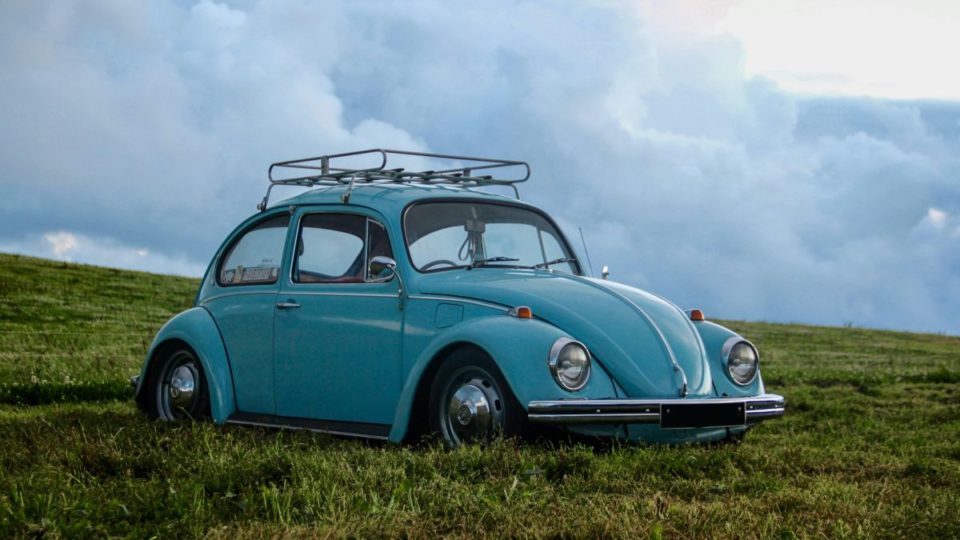 Blue VW Beetle parked in the grass
