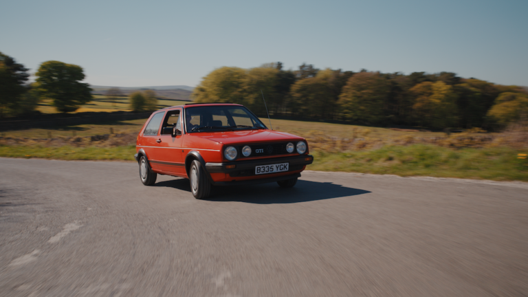 Cars that made the 80s the VW Golf Mk2 driving along a road